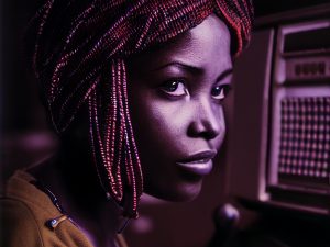 Africologist_35mm_photography_of_African_Griot_woman_programmin_bec9e434-ba37-43d4-9ca3-baa8f7bf01d4